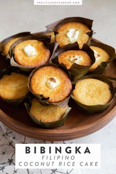 some food is on a wooden plate with the words bibingka coconut rice cakes