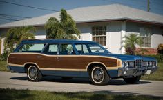 an old station wagon parked in front of a house