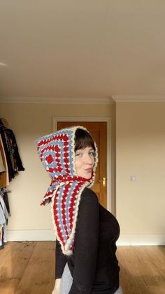 a woman wearing a knitted hat with an american flag design on the front and back