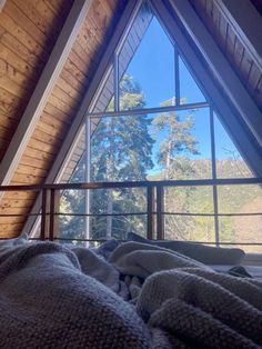 there is a window in the attic that looks out onto the trees outside and into the woods