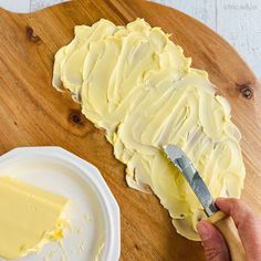 someone is spreading butter on top of the cake to make it look like they're ready