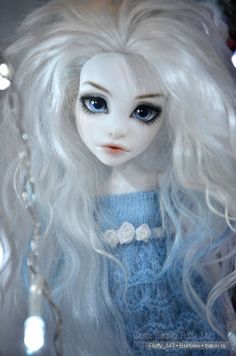 a doll with long white hair and blue eyes