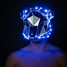 a man wearing a mask with blue lights on it's face and his shirtless torso