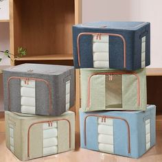 three suitcases stacked on top of each other in the middle of a room with wood flooring