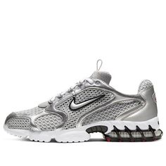 The Nike Air Zoom Spiridon Cage 2 Metallic Silver combines retro flair with futuristic design. Crafted for men, this sneaker features a mesh and synthetic leather upper coated in a sleek metallic silver finish. The raised Swoosh branding on the quarter panel adds a bold touch. Underfoot, a white foam midsole houses a caged Zoom Air unit in the heel for cushioning. The rubber outsole introduces hits of red for a pop of color. Whether you’re hitting the streets or making a style statement, these k Silver Nike Sneakers, Nike Spiridon Cage 2 Outfit, Nike Air Zoom Spiridon Cage 2, Silver Sneakers Outfit 2024, Silver Sneakers Outfit, Futuristic Fashion Aesthetic, Nike Air Zoom Spiridon, Nike Gym Shoes, Gym Sneakers