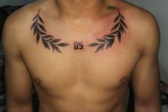 a man's chest is adorned with black leaves