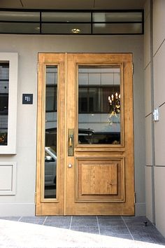 the front door to a building with two glass doors