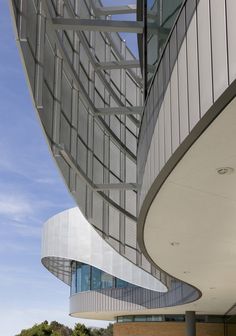 an architectural view of a curved building