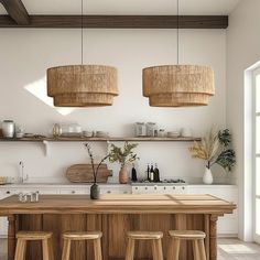 the kitchen is clean and ready to be used for cooking or eating, with two hanging lights above the island