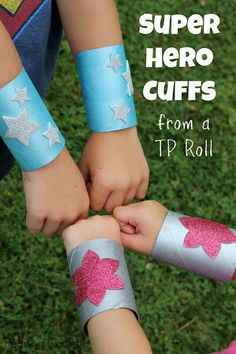 two children holding hands with the words super hero cuffs from a tp roll on them