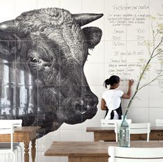 a large bull head sitting on top of a wooden table