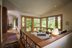 a living room filled with furniture and lots of windows