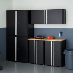 a black refrigerator freezer sitting inside of a kitchen next to a wooden counter top