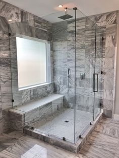 a walk in shower sitting next to a window with a bench on it's side