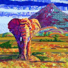 an elephant standing in the middle of a field with mountains in the backgroud