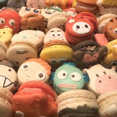 many different colored donuts with faces on them