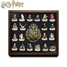 a harry potter figurine set in a wooden frame with the hogwarts crest