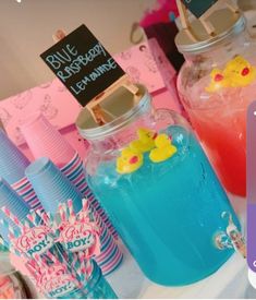 there are many different colored drinks on the table with paper straws and candy sticks