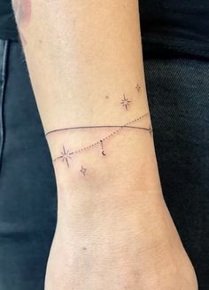 a woman's wrist with a star tattoo on it