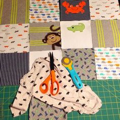 scissors and some fabric on a cutting board with other items to sew or sew