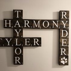 three wooden crosses with words written on them and a dog's paw in the center