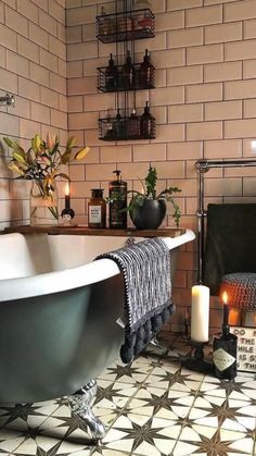 a bath tub sitting next to a fire place in a bathroom with tiled flooring