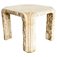 a white marble table with an intricate design on the top and bottom, against a white background