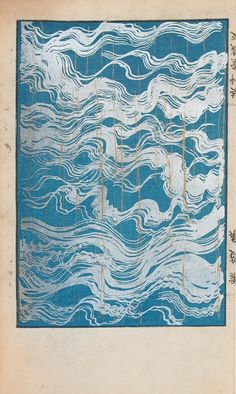 an old book with blue and white designs on the pages, including lines in the water