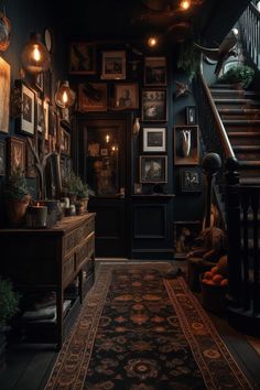 a dark room with stairs and pictures on the wall