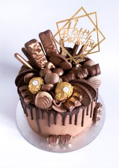 a birthday cake decorated with chocolate and gold decorations