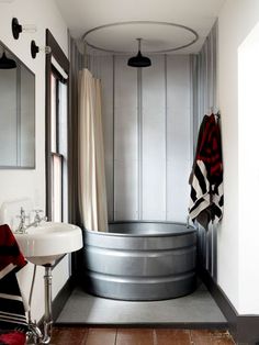 a bathroom with a tub, sink and mirror