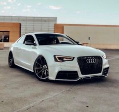 a white car parked in an empty parking lot