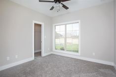 an empty room with a ceiling fan in it