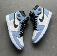 pair of blue and white sneakers on cement surface