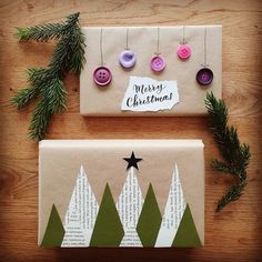 two christmas cards with buttons on them sitting next to evergreen branches and pine cones hanging from strings