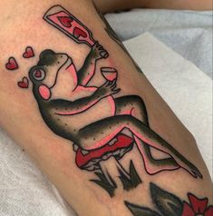 a tattoo on the leg of a woman with a knife in her hand and hearts coming out of it