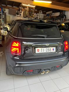 two cars parked in a garage next to each other