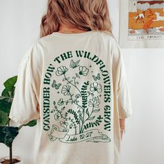 "\"Consider the wildflowers\" adorable graphic tee with design on the front and back.  *This design is printed in green ink.  Comfort colors t shirts a relaxed fit but if you want it significantly oversized I suggest ordering a size up.  Comfort Colors introduces its garment-dyed t-shirt; made 100% with ring-spun cotton. The soft-washed, garment-dyed fabric brings extra coziness to your wardrobe while the relaxed fit makes it an excellent daily choice. The double-needle stitching throughout the tee makes it highly durable while the lack of side-seams helps the shirt retain its tubular shape. .: 100% ring-spun cotton .: Heavy fabric (6.1 oz/yd² (206.8 g/m .: Relaxed fit .: Sewn-in twill label" Green T-shirt With Front Print For Spring, Spring Green T-shirt With Custom Print, Green Custom Print T-shirt For Spring, Consider The Wildflowers, Vintage Shirt Design, Womens Graphic Tee, Oversize Tshirt Outfits, Christian Shirts Designs, Faith Based Clothing