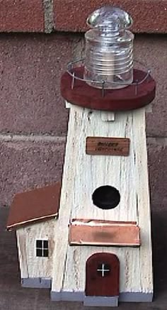 a bird house with a water bottle on top