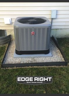 an air conditioner sitting in the grass next to a building