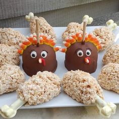 chocolate covered donuts decorated like turkeys with candy sticks sticking out of their mouths