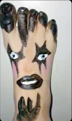 someone has their hands painted with black and white makeup