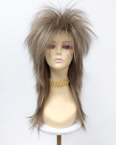 "Rock out in true punk fashion with 80s-style long spiky rockstar layers! Inside cap has adjustable elastic straps, no combs or clips. Color: Light Ash Brown  and Ash Blonde  (18/22) Length: 20 Inches Circumference: Default at 21\" with adjustable cap (max 22\") All sales are final. Please read all store policies before purchasing." 80s Style Hair, Rocker Costume, Punk Mode, Messy Pixie Haircut, Medium Shaggy Hairstyles, Modern Shag Haircut, Short Spiky Haircuts, Short Shaggy Haircuts, Funky Short Hair