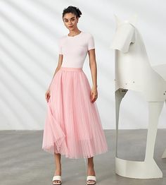 Look your best in the Prestigious Tulle Pleated Flowy Maxi Skirt. This lightweight and comfortable skirt is crafted from soft tulle that is pleated for maximum comfort. Its flowy skirt design adds a touch of class and elegance to your wardrobe. Perfect for formal occasions or everyday wear. 100% Polyester Imported Elegant pleated design: This pleated skirt features a beautiful pleated design that creates a flowing, elegant silhouette. The pleats are evenly spaced and give the skirt a luxurious t Spring Tulle Flared Pleated Skirt, Fitted Pleated Tulle Skirt, Summer Flared Tulle Pleated Skirt, Stretch Tulle Maxi Skirt For Spring, Sheer Feminine Skirt For Spring, Fitted Long Tulle Pleated Skirt, Pink Tulle Maxi Skirt For Summer, Stretch Full Tulle Maxi Skirt, Feminine Tulle Maxi Skirt For Summer