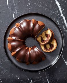 a chocolate bundt cake on a black plate