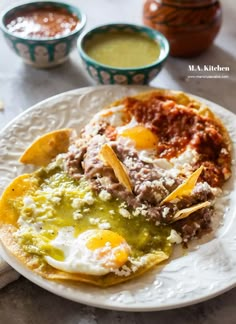 an egg is on top of some mexican food