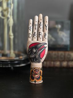 a hand painted with the words stay dark and an eagle on it is sitting on a table