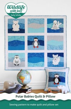 a quilted wall hanging with polar babies quilts and pillows on top of it