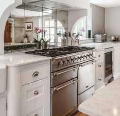 a kitchen with an oven, sink and counter tops in it's center island