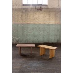 two benches in front of a brick wall